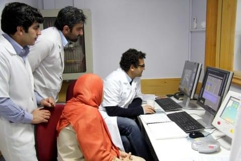 Dr Arshid Azarine and his medical team working on computers