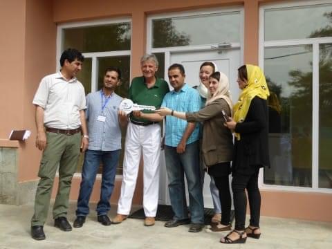 Handing-over of the Zanjir e Omed's House Group of people holding they key to the Zanjir e Omed's House